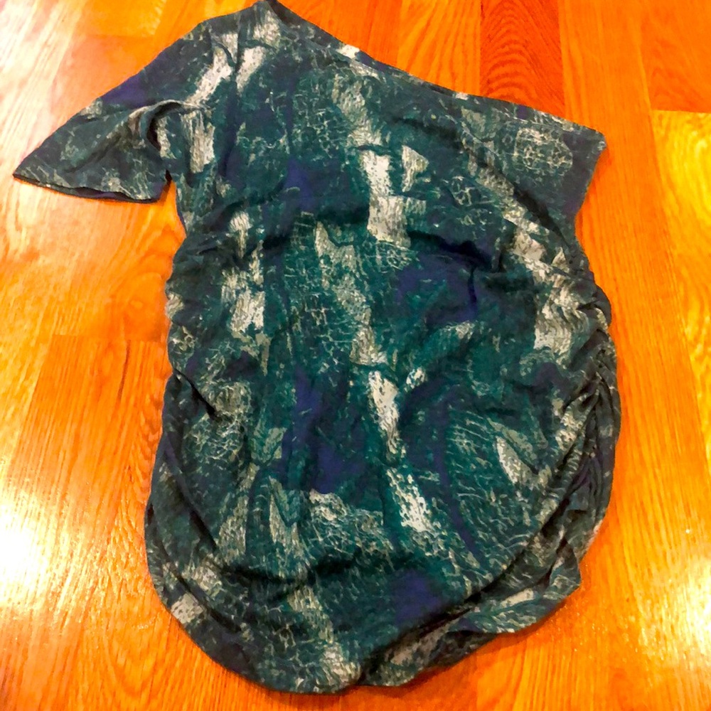 Dark green and blue shirt, off the shoulder.